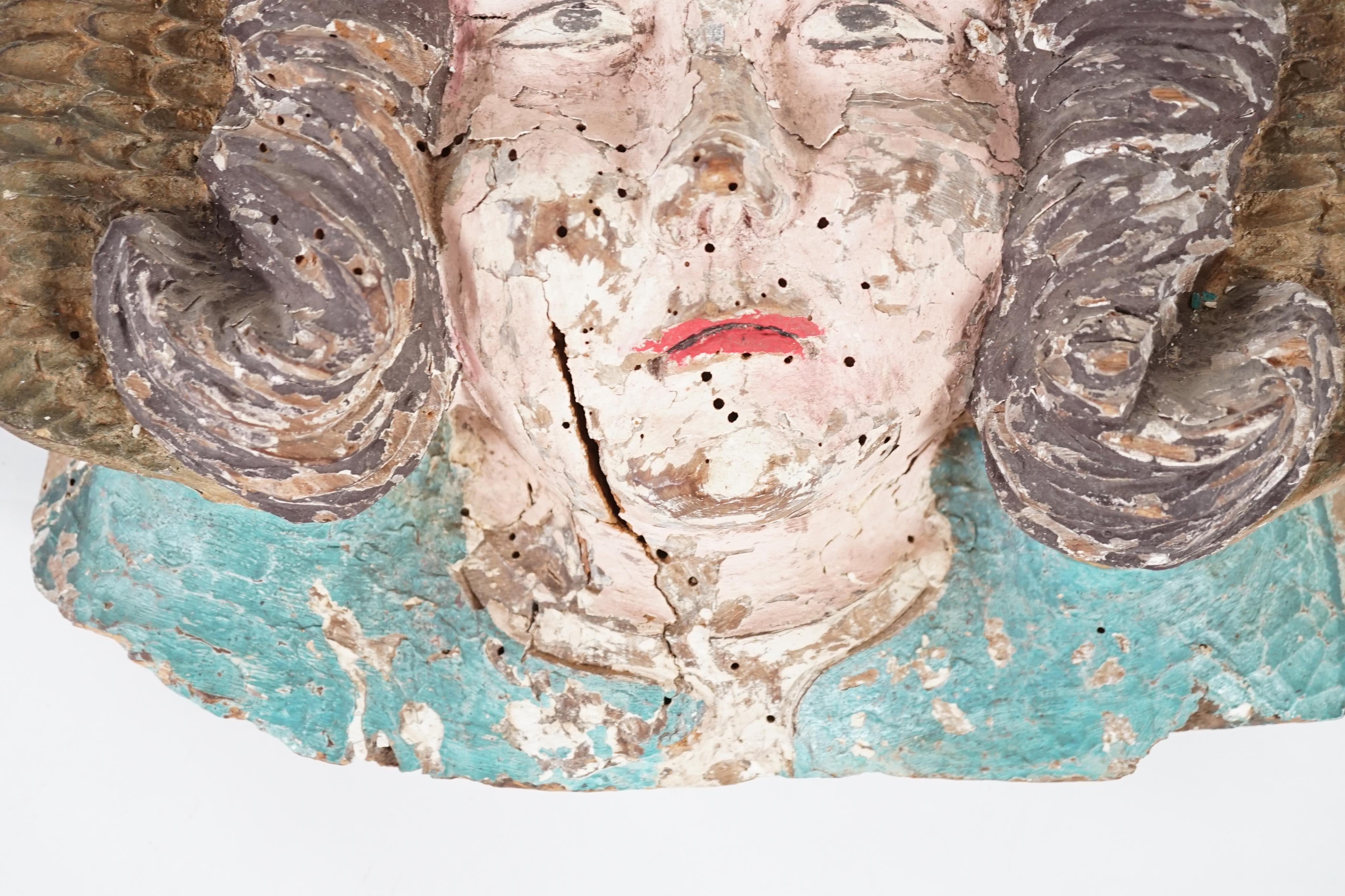 A 16th century French carved and painted wooden angel mask corbel